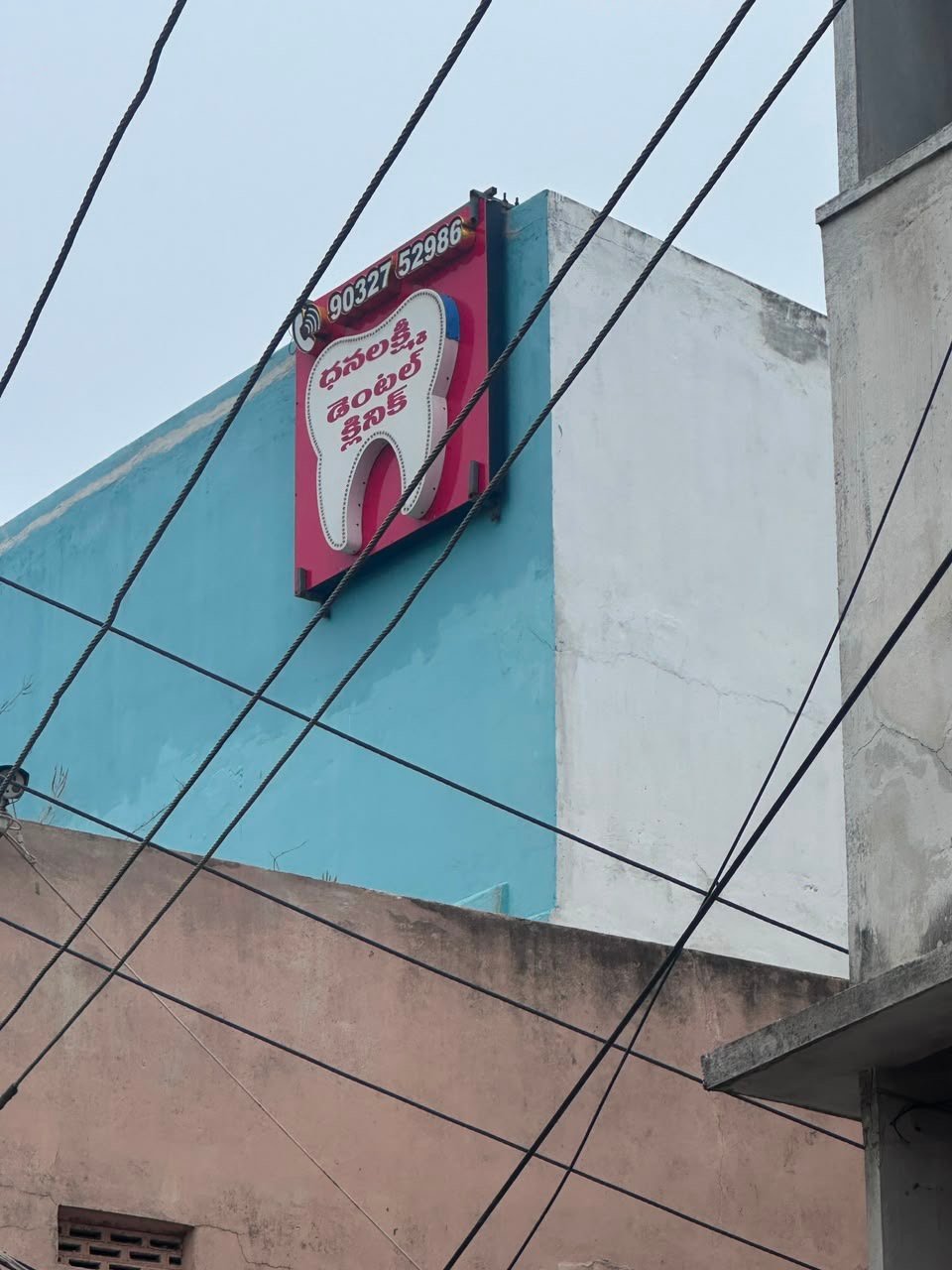 Exterior view of Sai Dental Plaza building housing Dhanalakshmi Dental Clinic